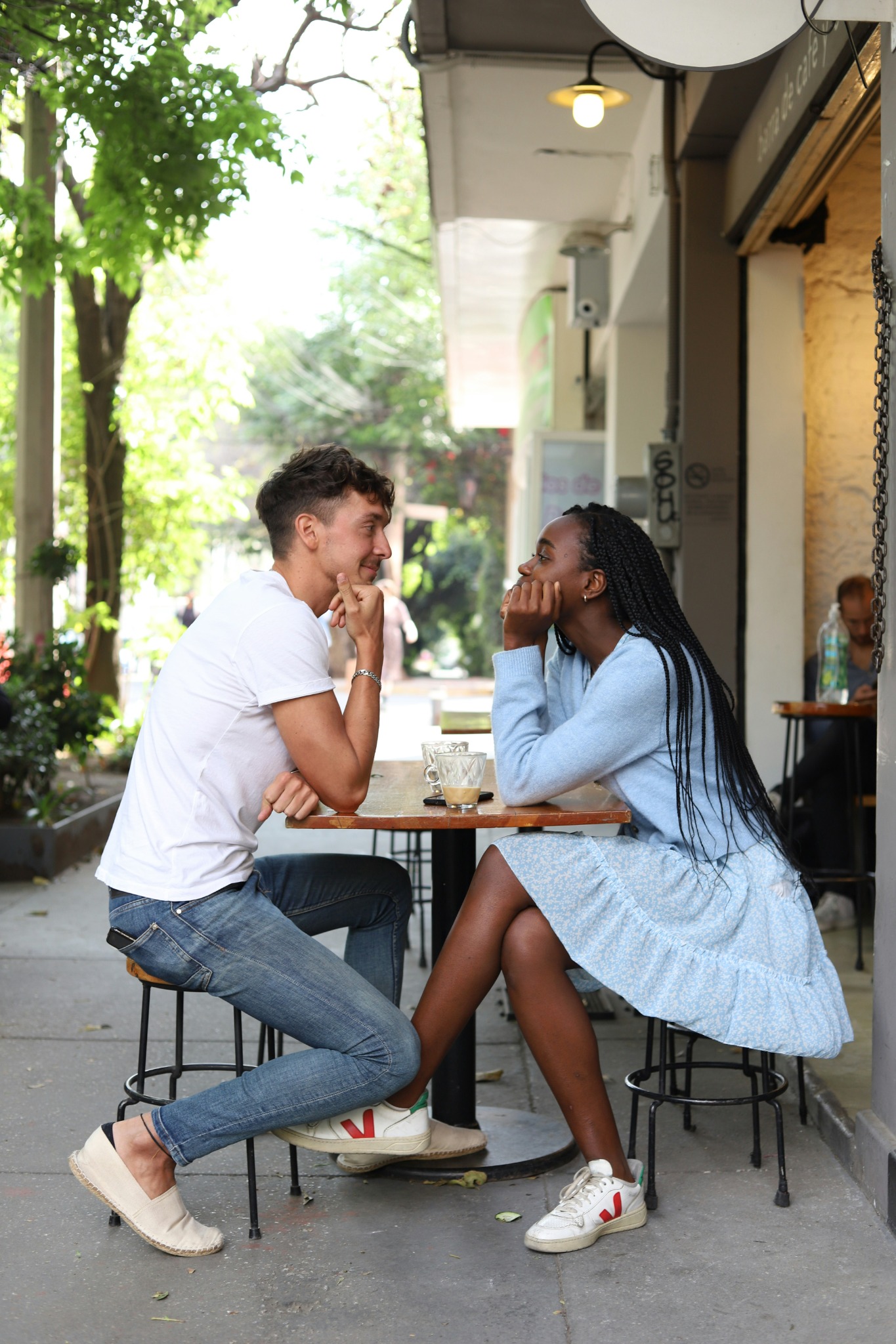 Couple on a café date smiling at each other